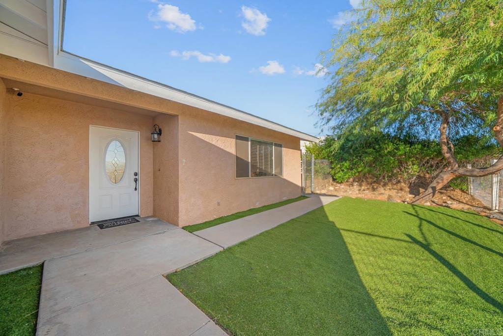 a view of house with backyard