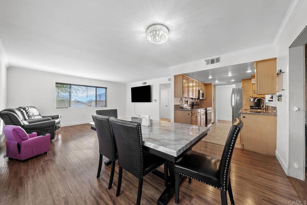 10981 Santa Cruz Road Desert Hot Springs, CA 92240 - Photo 11 of 43 a view of a dining room with furniture and wooden floor