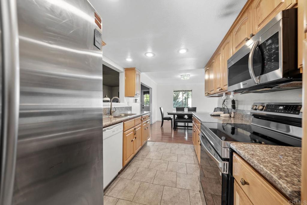 10981 Santa Cruz Road Desert Hot Springs, CA 92240 - Photo 12 of 43 a kitchen with stainless steel appliances granite countertop a sink and cabinets