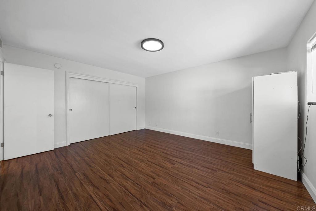 10981 Santa Cruz Road Desert Hot Springs, CA 92240 - Photo 16 of 43 a view of an empty room with wooden floor