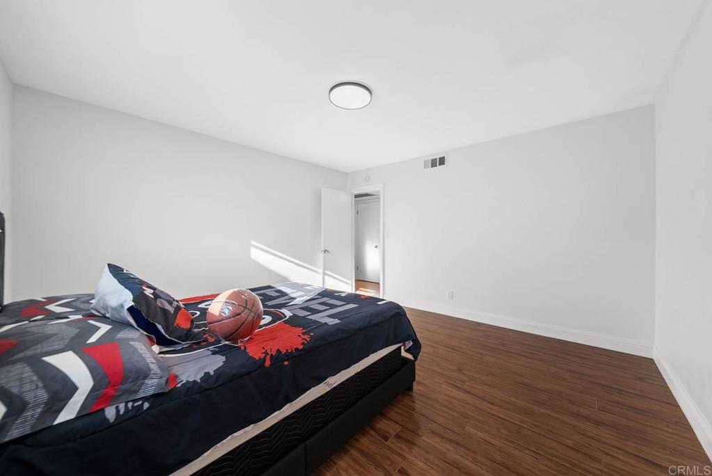 10981 Santa Cruz Road Desert Hot Springs, CA 92240 - Photo 17 of 43 a bedroom with a bed and wooden floor