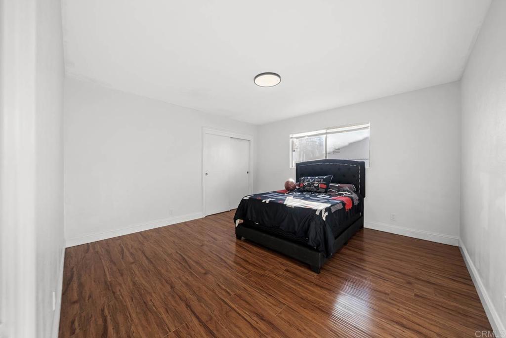10981 Santa Cruz Road Desert Hot Springs, CA 92240 - Photo 18 of 43 a bedroom with a bed and wooden floor