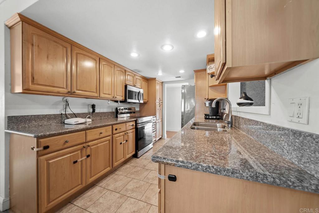10981 Santa Cruz Road Desert Hot Springs, CA 92240 - Photo 2 of 43 a kitchen with stainless steel appliances granite countertop a sink stove and refrigerator