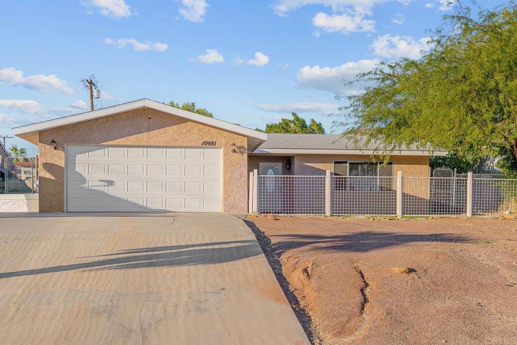 10981 Santa Cruz Road Desert Hot Springs, CA 92240 - Photo 27 of 43 a front view of a house with a yard