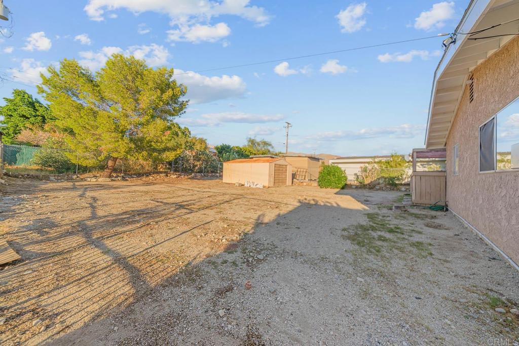 10981 Santa Cruz Road Desert Hot Springs, CA 92240 - Photo 30 of 43 a view of a yard with wooden fence