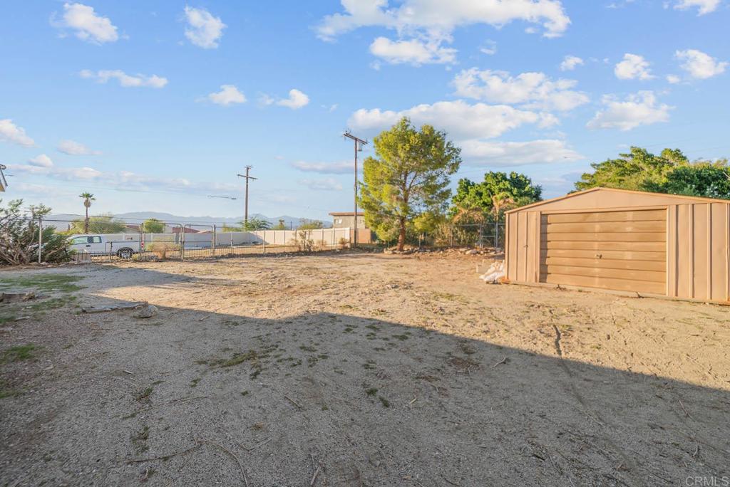 10981 Santa Cruz Road Desert Hot Springs, CA 92240 - Photo 31 of 43 a view of a dry yard with wooden fence