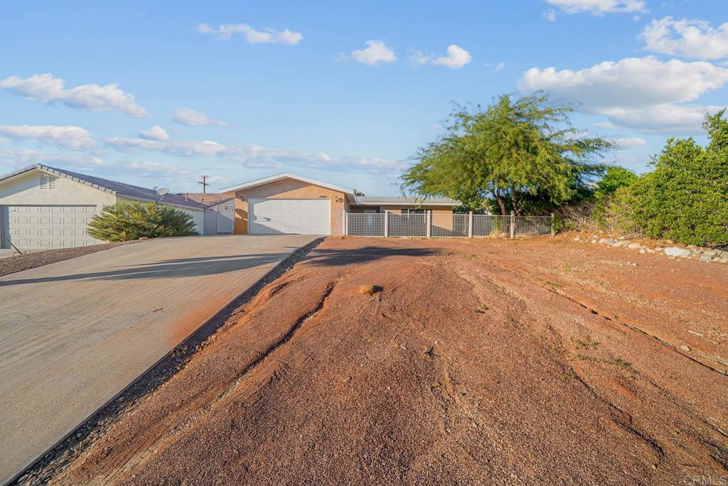 10981 Santa Cruz Road Desert Hot Springs, CA 92240 - Photo 33 of 43 a view of an house with backyard and trees