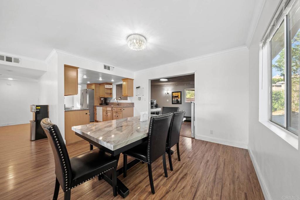 10981 Santa Cruz Road Desert Hot Springs, CA 92240 - Photo 9 of 43 a view of a dining room with furniture and wooden floor