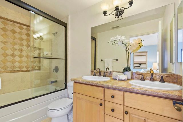 a bedroom with a bed and a painting on the wall