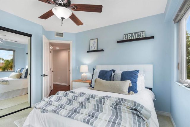 a kitchen with kitchen island granite countertop a table chairs stove and cabinets