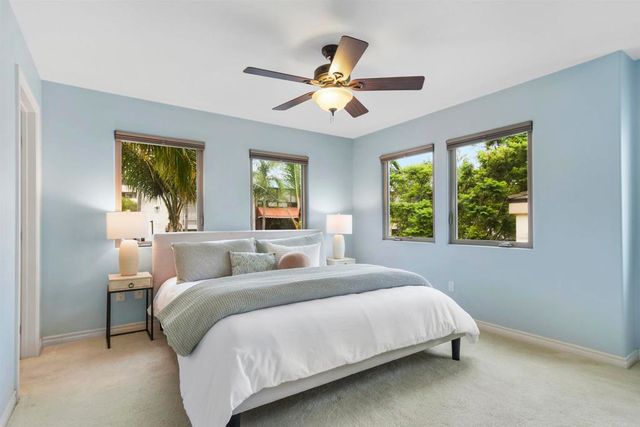 a bathroom with a granite countertop sink toilet mirror and shower