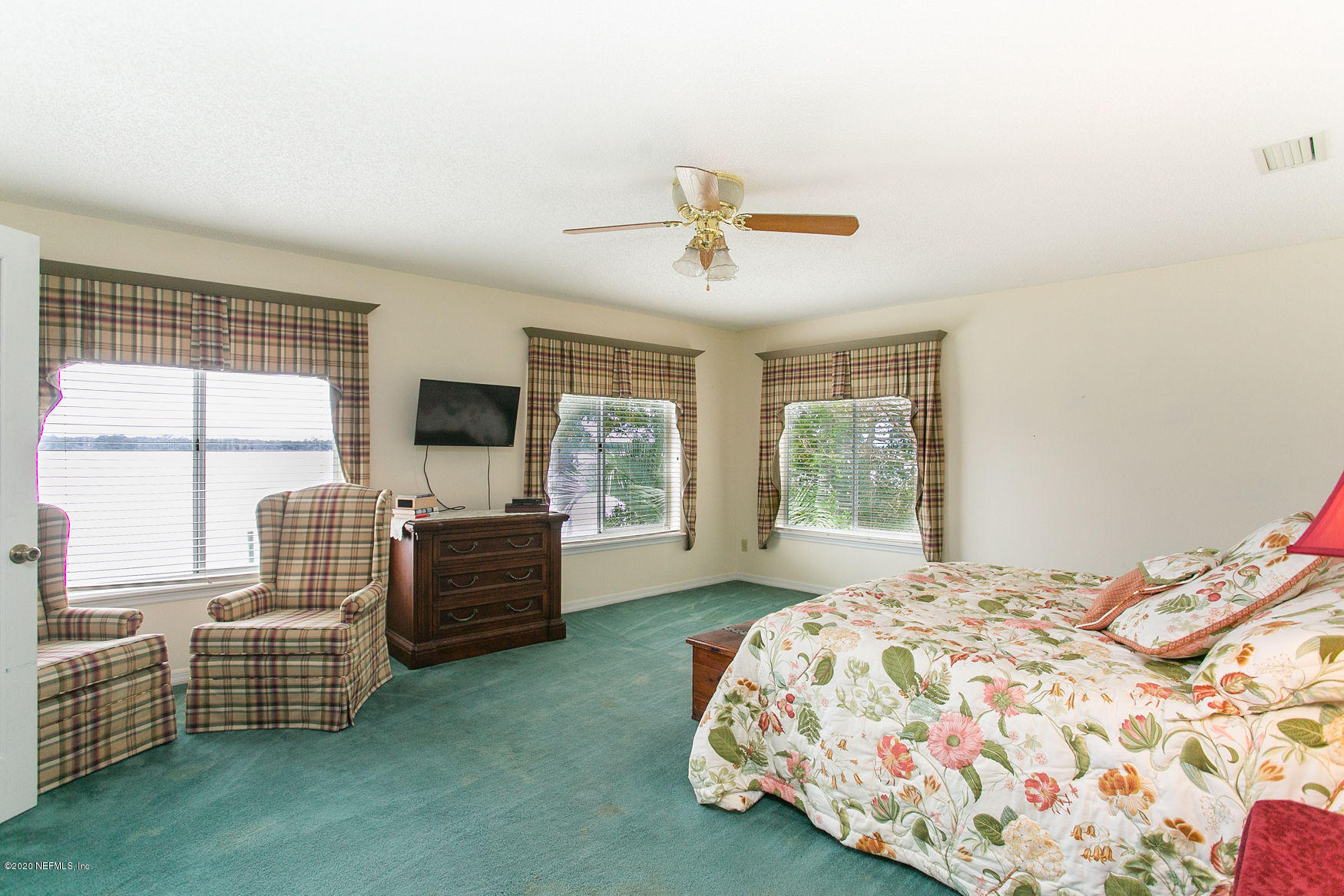 6317 Salado Road St. Augustine, FL 32080 - Photo 29 of 51 a spacious bedroom with a bed and a couch