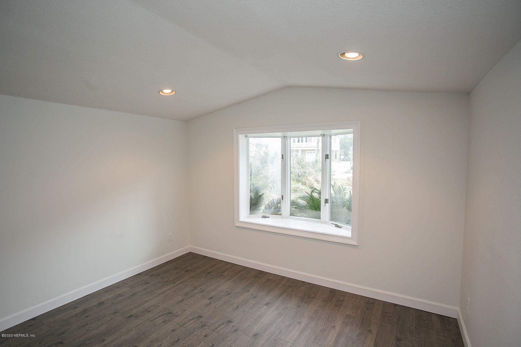 6317 Salado Road St. Augustine, FL 32080 - Photo 38 of 51 an empty room with wooden floor and windows