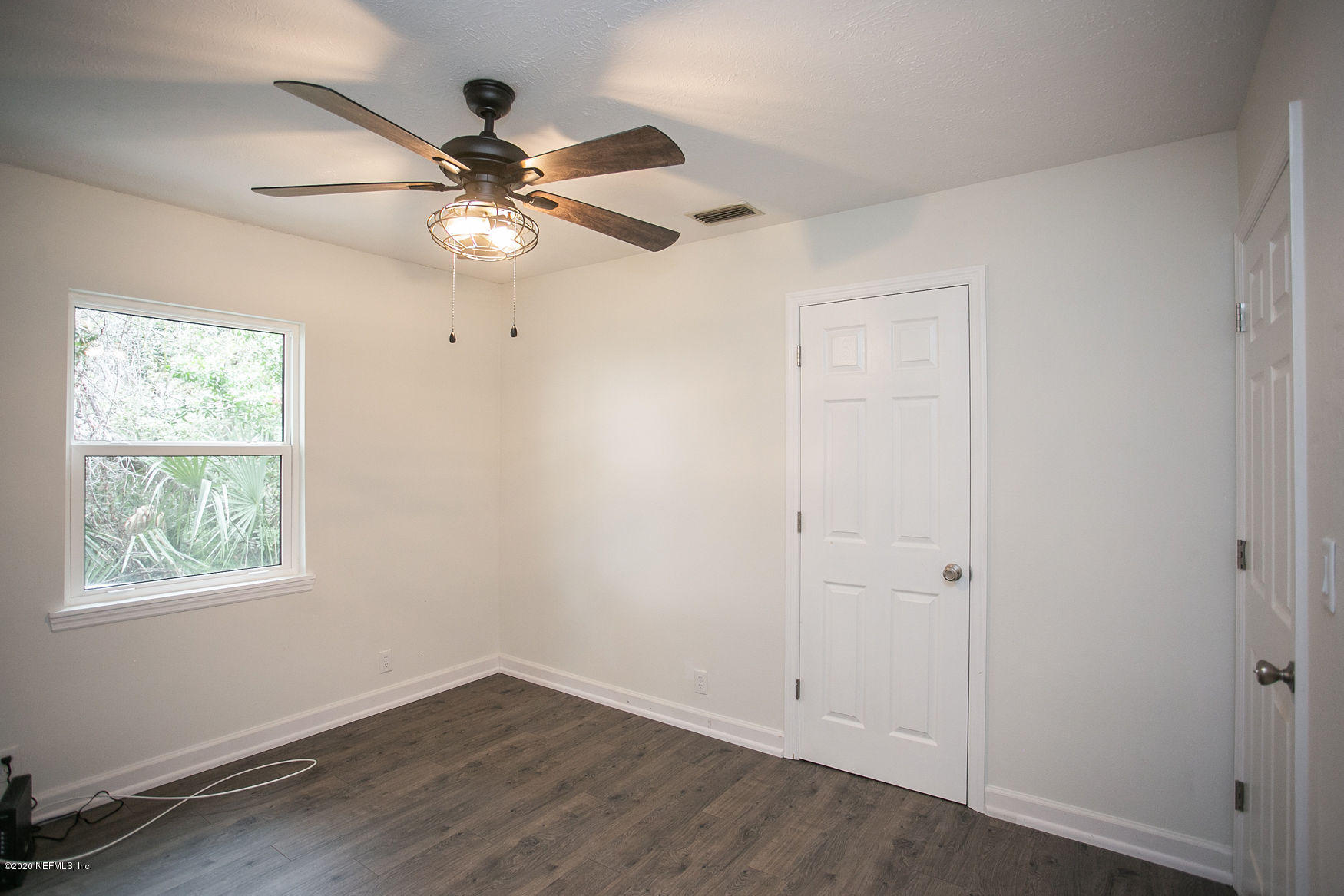 6317 Salado Road St. Augustine, FL 32080 - Photo 44 of 51 wooden floor in an empty room with a window