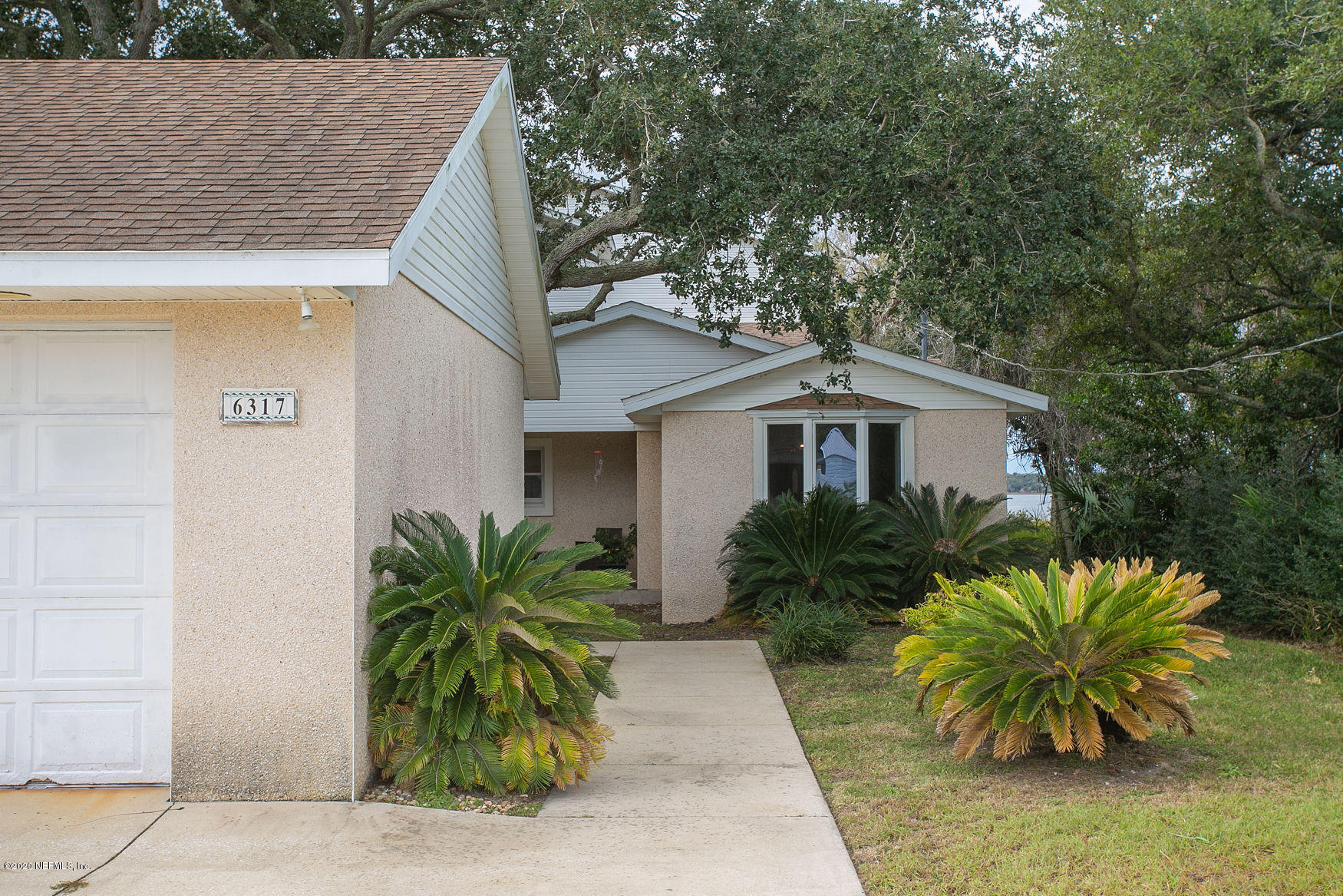 6317 Salado Road St. Augustine, FL 32080 - Photo 5 of 51 a house that has a tree in front of it