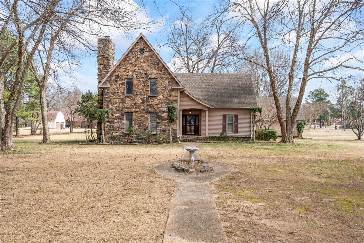 4590 Whiteoaks Lane Bartlett, TN 38002 - Photo 2 of 40 a backyard of a house with trees and outdoor space