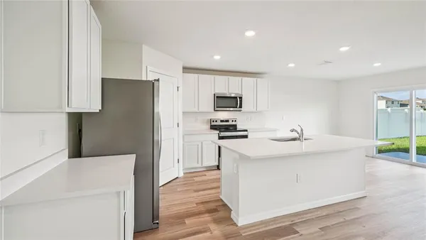 a kitchen with a sink a stove a refrigerator and a refrigerator