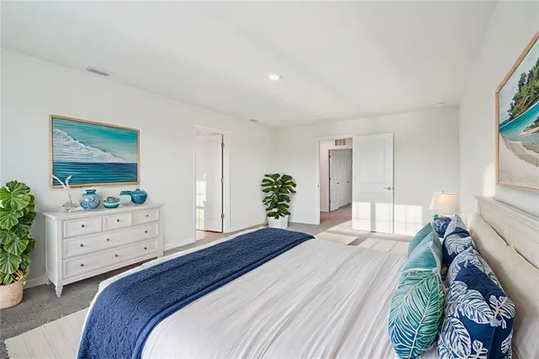 a bedroom with a bed and a dresser in it