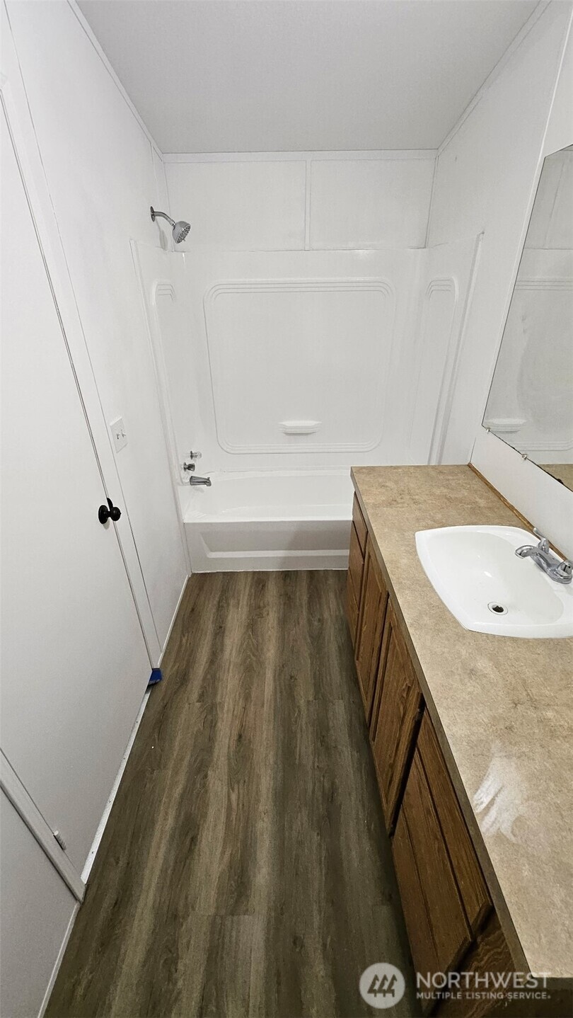 5705 Littlerock Road Southwest, Unit 32 Tumwater, WA 98512 - Photo 4 of 6 a bathroom with a granite countertop sink and a mirror