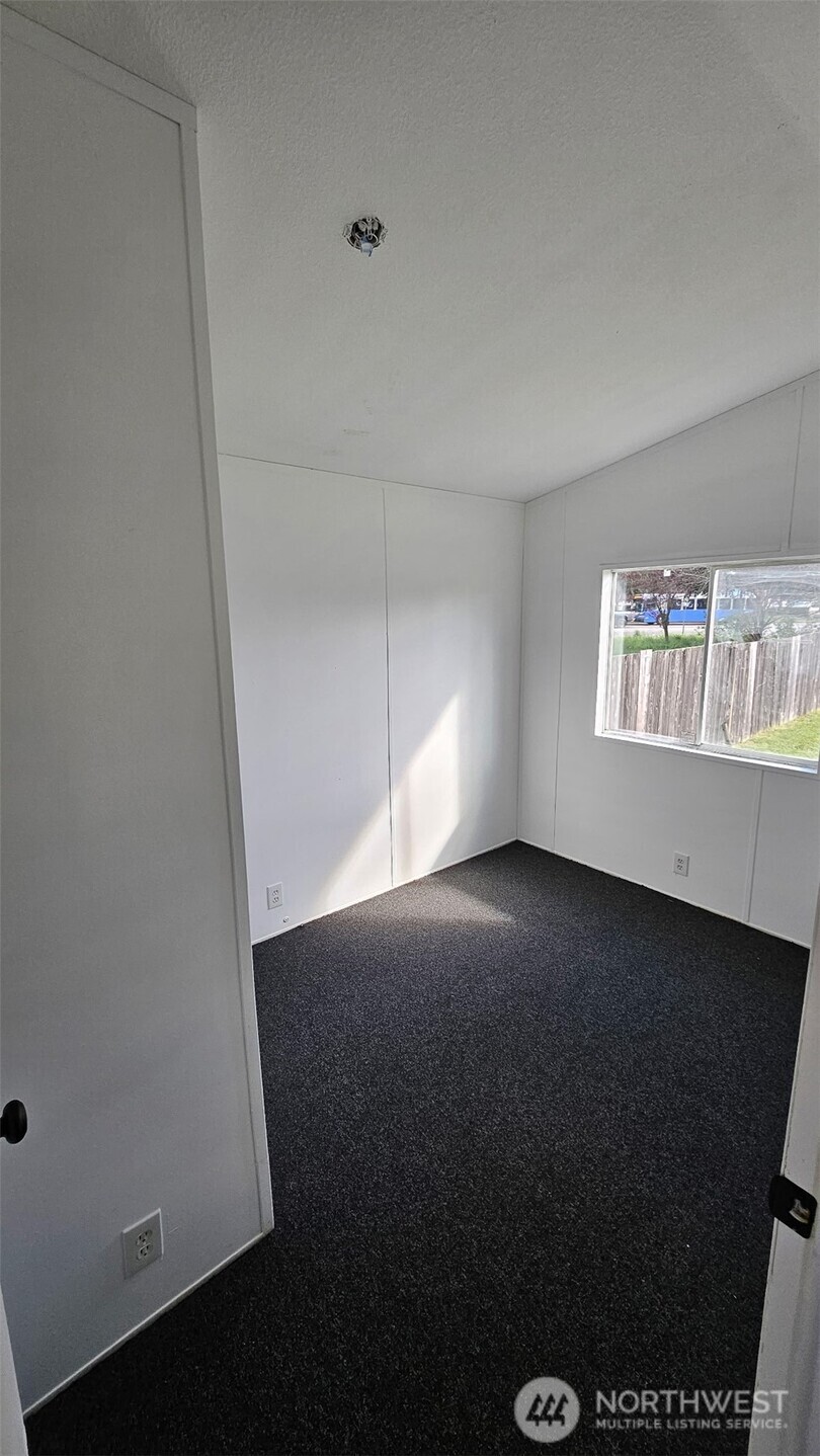 5705 Littlerock Road Southwest, Unit 32 Tumwater, WA 98512 - Photo 5 of 6 an empty room with windows