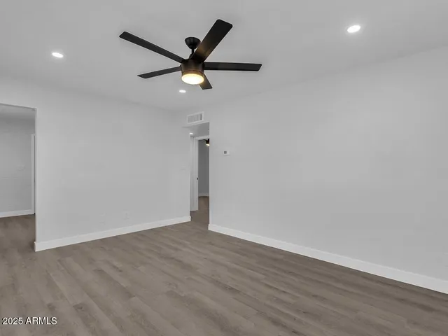 a view of a big room with wooden floor windows