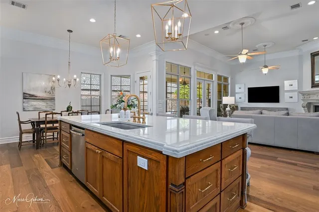 a kitchen with stainless steel appliances granite countertop a kitchen island a stove and a sink