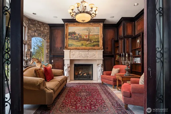 a living room with furniture a fireplace and a flat screen tv
