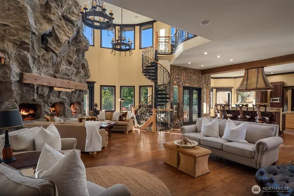 a living room with furniture a large window and a fireplace
