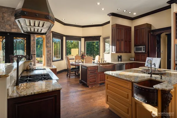 a kitchen with sink stove and cabinets