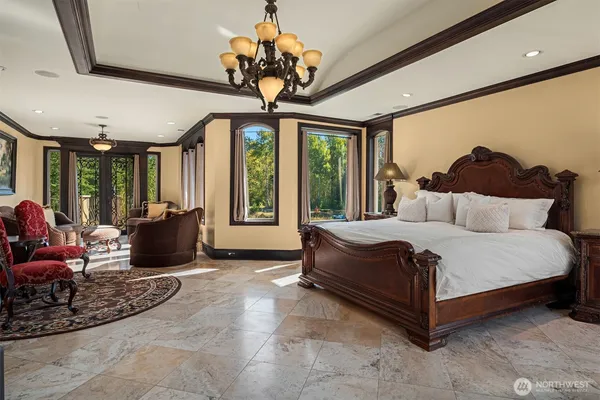 a bed room with a bed and a chandelier