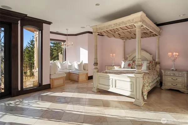 a bedroom with a large bed and a large window