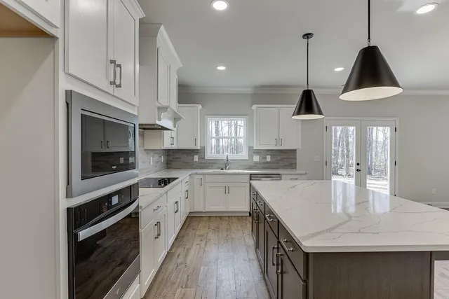 a kitchen with a sink stainless steel appliances and cabinets
