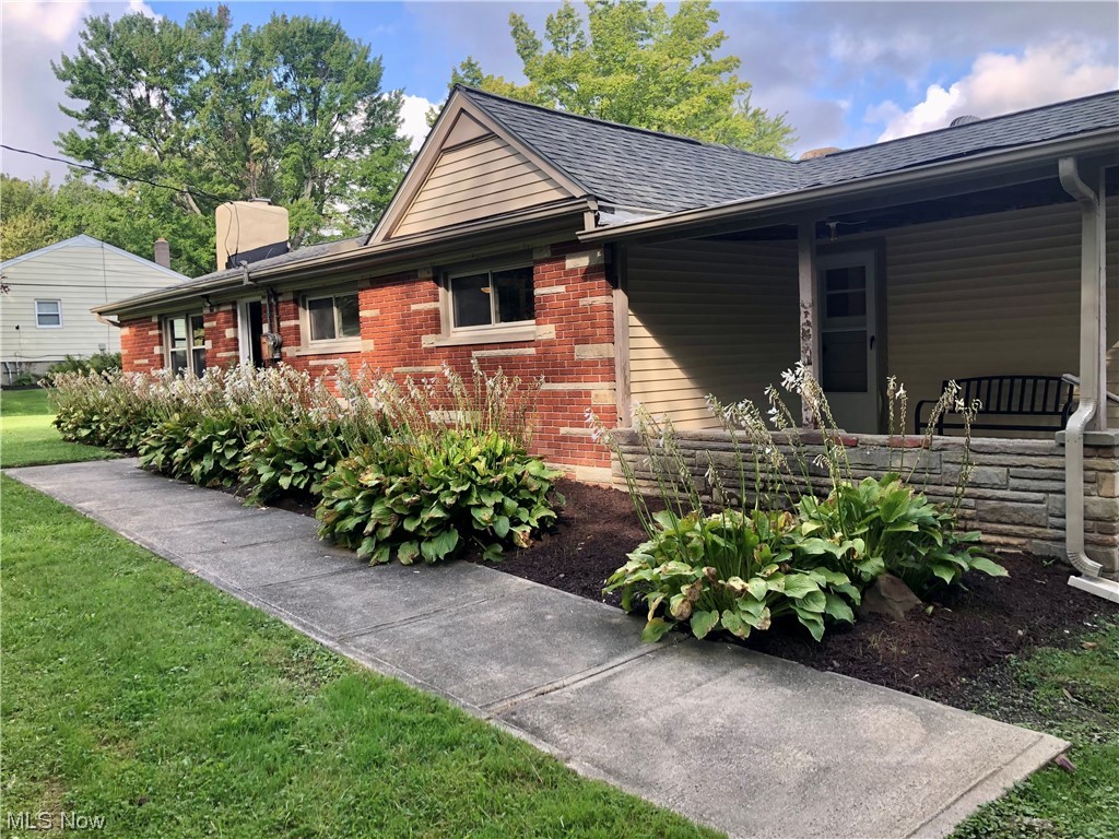 Ranch-style home with a covered side porch
