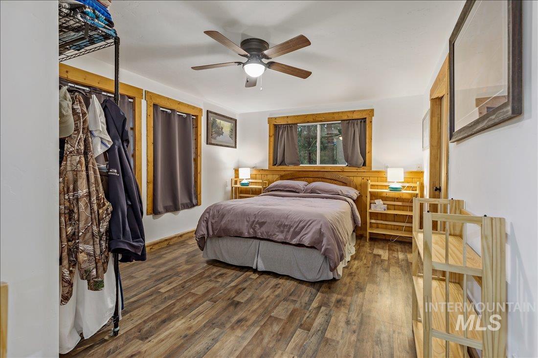 79 Sunset Loop Cascade, ID 83611 - Photo 31 of 44 Bedroom featuring wood-finish flooring, wood trim, and a ceiling fan
