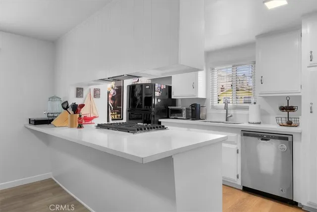 a kitchen with a sink a stove and cabinets