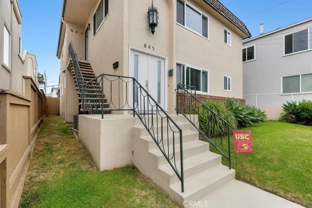 a front view of a house with a garden
