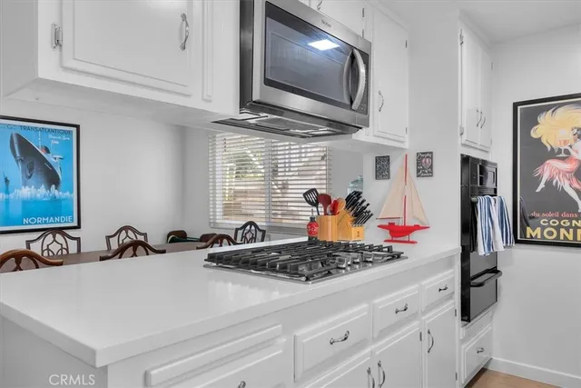 a kitchen with stainless steel appliances granite countertop a sink and a window