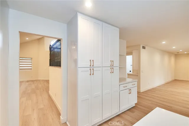 a view of a hallway with two chairs