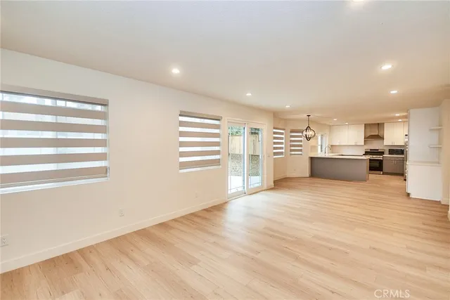 a view of a kitchen with a stove top oven and cabinets