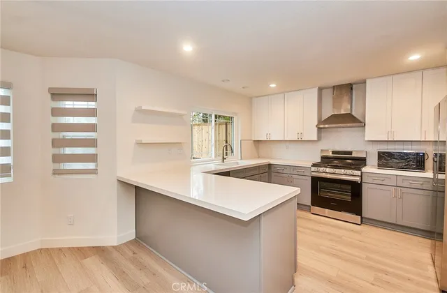 a kitchen with stainless steel appliances granite countertop a stove and a sink