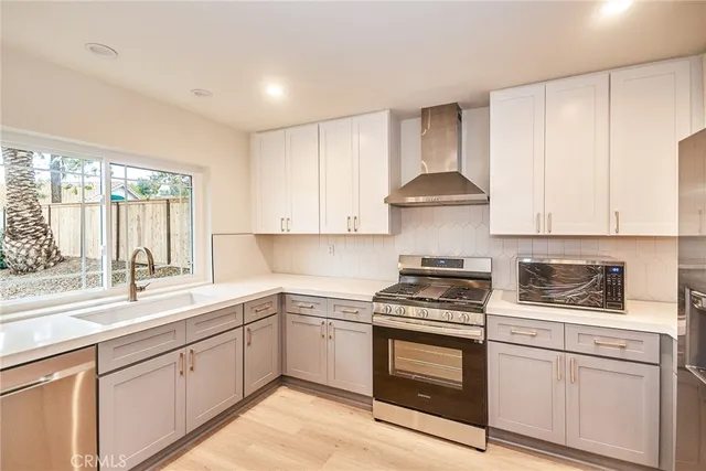 a kitchen with cabinets stainless steel appliances and a sink