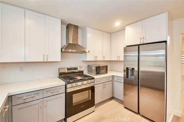 a kitchen with white cabinets and white appliances