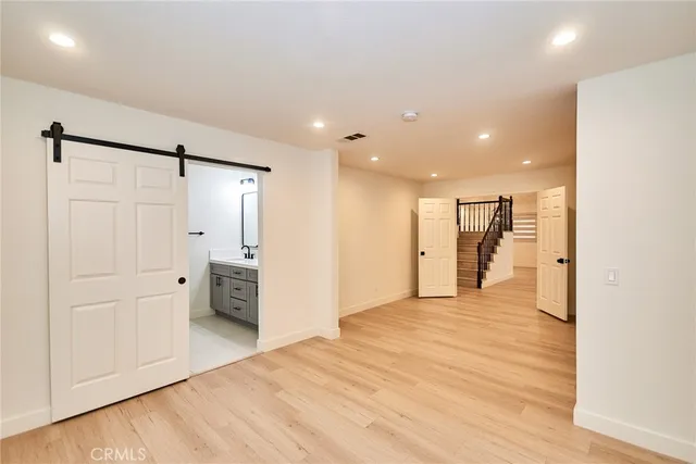 a view of a kitchen with a refrigerator and a stove top oven
