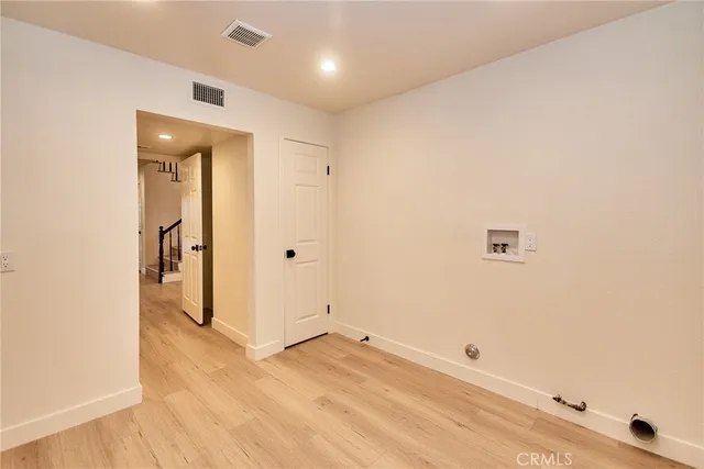 a view of staircase and kitchen with wooden floor