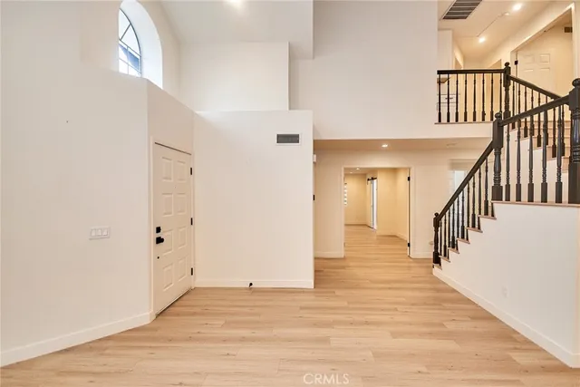 a view of a hallway with wooden floor and entryway