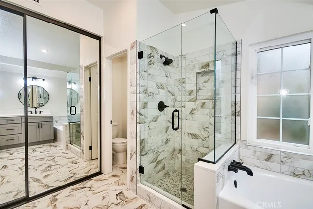 a bathroom with a bathtub and a shower