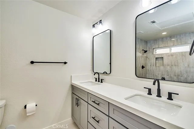 a bathroom with 2 sink and a mirror