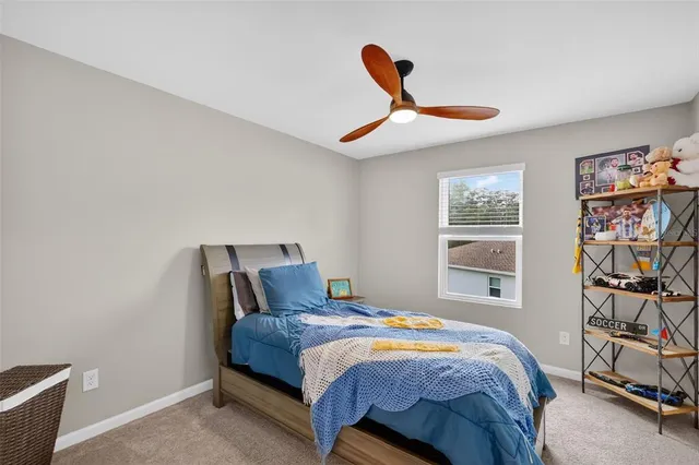 a bedroom with a bed and a book shelf