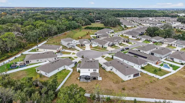 an aerial view of residential houses with outdoor space