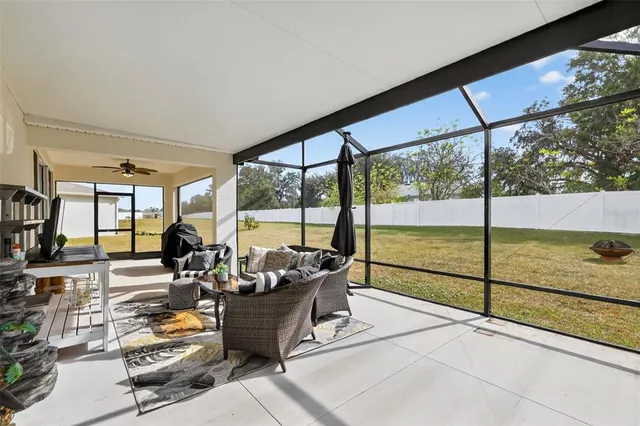 a living room with furniture and a floor to ceiling window